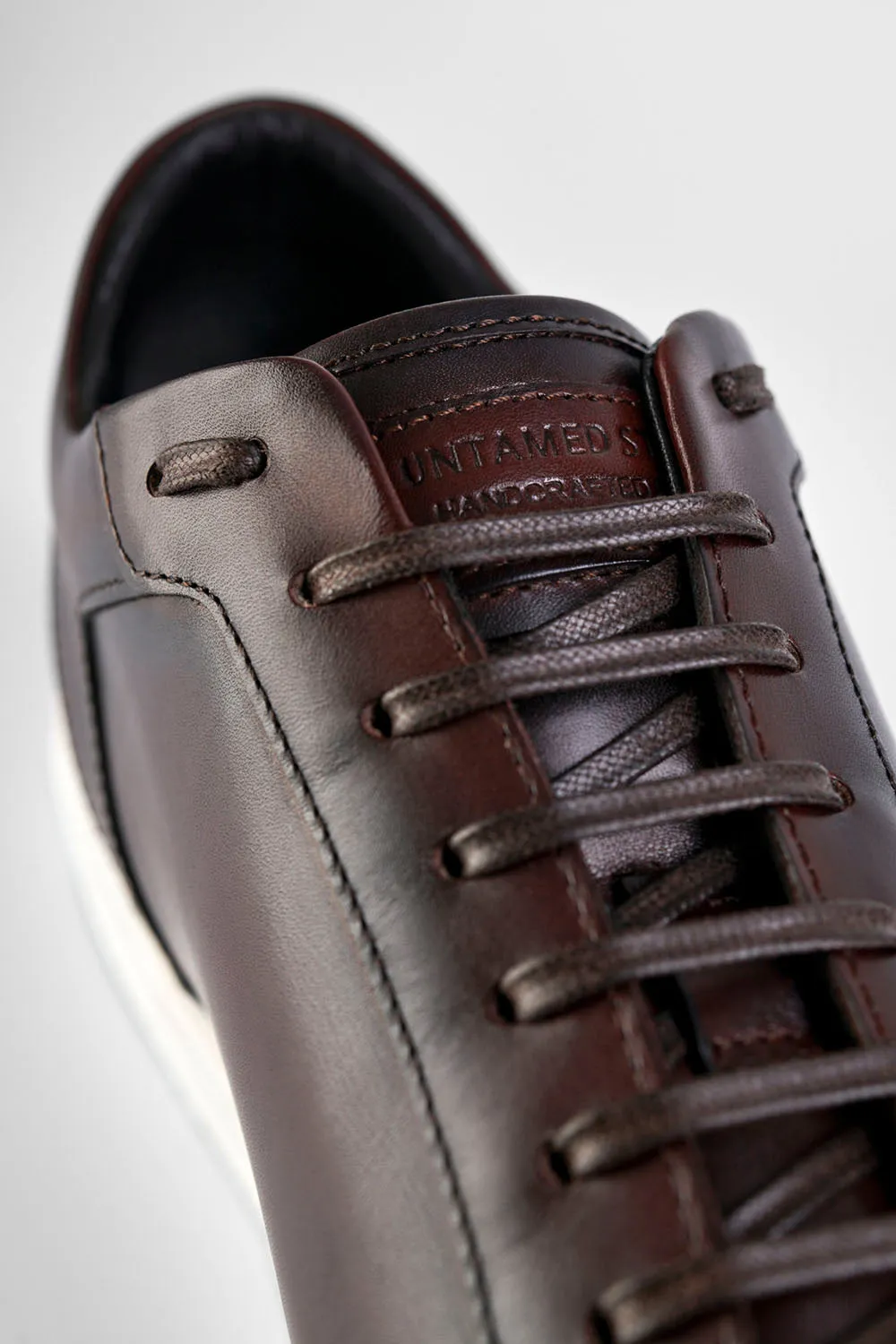 SOHO chestnut patina sneakers.